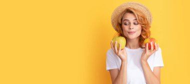 Summer girl hold apple. cute redhead woman in straw hat hold apple, health. Beauty woman isolated face portrait, banner with mock up copy space