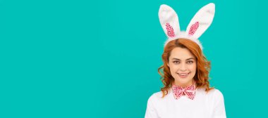happy easter woman in bunny ears and bow tie on blue background. Woman isolated face portrait, banner with mock up copyspace