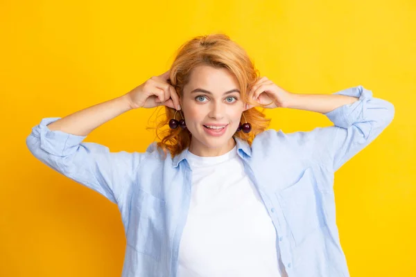 Stock image Young woman eats sweet cherries. Portrait of a beautiful girl with cherry on yellow background. Summer fruit picking season. Natural vitamins