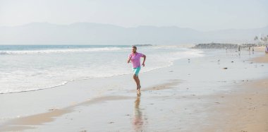 sport athletic man running on summer beach for training, freedom.