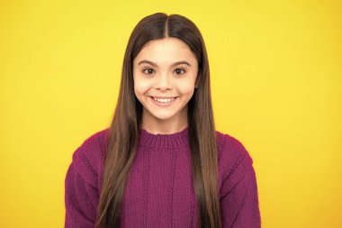 Close up emotional portrait of caucasian smiling teen girl. Head shot of cute teenager child on isolated studio background