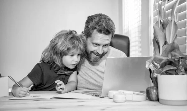 boy do homework with private teacher. webinar video lesson. online education on laptop. homeschooling and elearning. back to school. togetherness. father and son use computer at home. family blog.