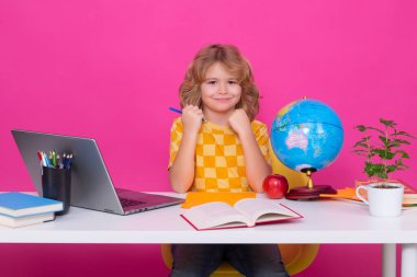 School and education concept. Portrait of cute child school boy isolated on pink red studio background. Back to school