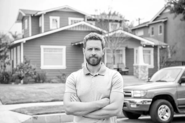 stock image man purchasing house for investment purpose. property insurance services. ownership. american settlement agent. house and car. real estate agent sell property. realtor in suburb neighborhood.