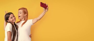 Mother and daughter kid banner, copy space, isolated background. modern life. mobile technology. having video call. mother and daughter vlogging