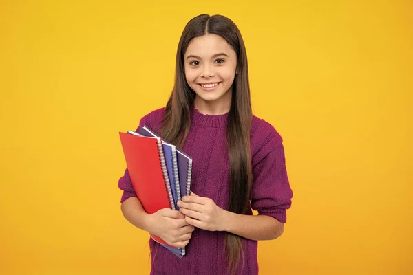 stock image Teen girl pupil hold books, notebooks, isolated on yellow background, copy space. Back to school, teenage lifestyle, education and knowledge