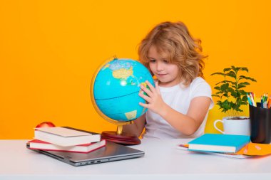 School and education concept. Portrait of cute child school boy, isolated on yellow background. Back to school