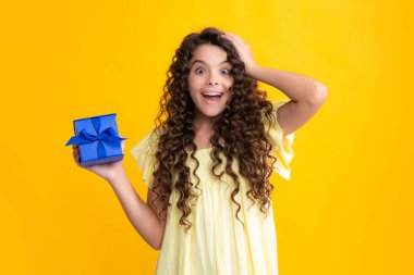 Hediye kutusu olan ergen bir çocuk. Tatil hediyesi. Mutlu yıllar, Sevgililer Günü, Yeni Yıl ya da Noel. Çocuk hediye kutusunu tut. Heyecanlı bir genç, şaşkın ve neşeli duygular içinde