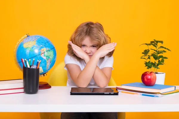 Stop bullying. Sad and angry pupil. School child studying in classroom at elementary school. Kid studying on lesson on yellow isolated background. Little student, smart nerd pupil