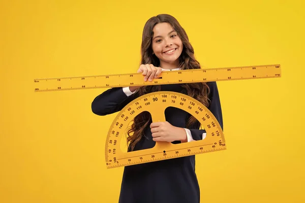 stock image Measuring school equipment. Schoolgirl holding measure for geometry lesson, isolated on yellow background. Student study math