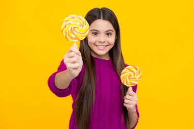 Teenage girl with lollipop, child eating sugar lollipops, kids sweets candy shop