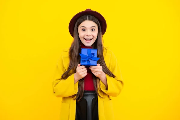 stock image Happy teenager portrait. Emotional teenager child hold gift on birthday. Funny kid girl holding gift boxes celebrating happy New Year or Christmas. Smiling girl