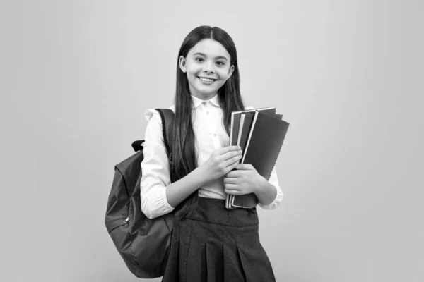 stock image School teenager child girl with school backpack hold book and copybook. Teenager student, isolated background. Learning and knowledge. Go study