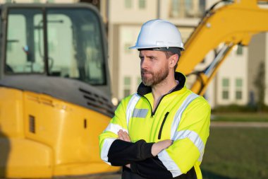 Worker at building site. Construction manager in helmet. Male construction engineer. Architect at a construction site. Handyman builder in hardhat. Building concept. Builder foreman