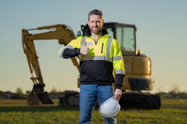 Worker at building site. Construction manager in helmet. Male construction engineer. Architect at a construction site. Handyman builder in hardhat. Building concept. Builder foreman