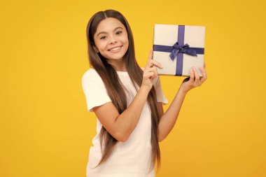 Happy teenager portrait. Teenager kid with present box. Teen girl giving birthday gift. Present, greeting and gifting concept. Smiling girl