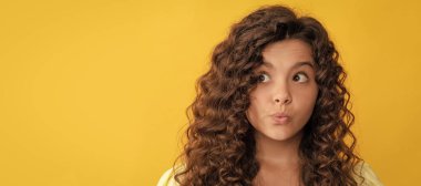 girl has wavy hairdo. portrait of frizz child. express positive emotion. Child face, horizontal poster, teenager girl isolated portrait, banner with copy space