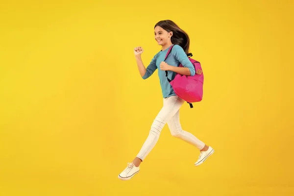 stock image School teen with backpack. Teenager student, isolated background. Learning and knowledge. Go study. Run and jump. Education concept. Happy teenager portrait. Smiling girl