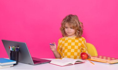 School child. Kid boy from elementary school. Pupil go study. Clever schoolboy learning isolated on pink red studio background. Kids study, knowledge and education