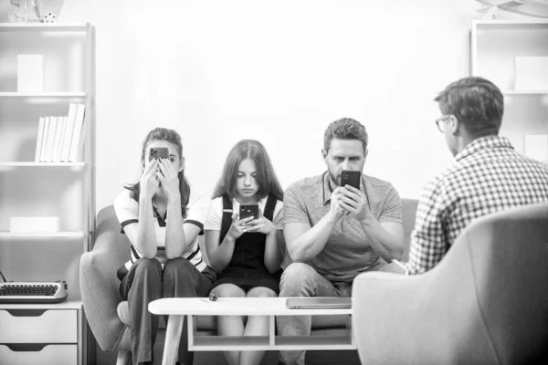 Stock image psychologist give family therapy for phone addicted dad mom and daughter girl, internet.