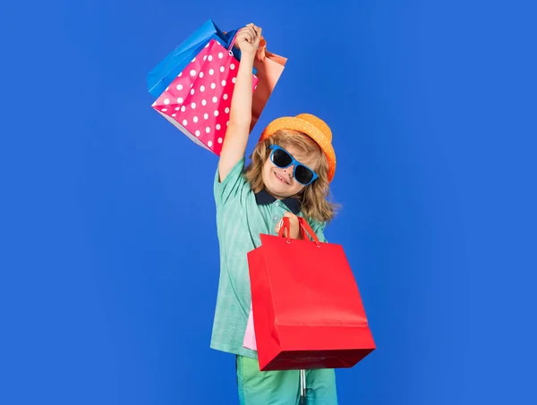 兴奋的小买家孩子在购物 一个拿着购物袋的孩子的画像穿着衬衫 戴着太阳镜和帽子的时髦孩子 黑色星期五购物 — 图库照片