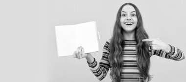 Going back-to-school on September 1. Happy child point finger at open book. Banner of schoolgirl student. School child pupil portrait with copy space
