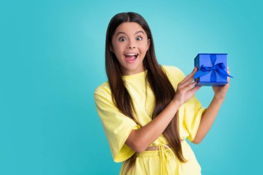 Cute teenager child girl congratulate with valentines day, giving romantic gift box. Present, greeting and gifting concept. Birthday holiday concept. Excited face of teenager girl