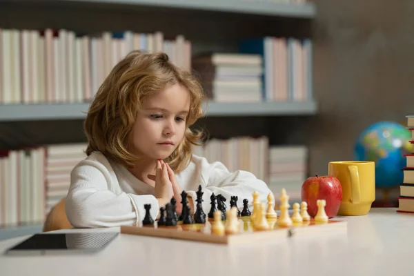 Stock image Smart kid playing chess. Clever child thinking about chess. Brain development and logic