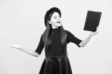 Teen girl pupil hold books, notebooks, isolated on yellow background, copy space. Back to school, teenage lifestyle, education and knowledge. Excited teenager, glad amazed and overjoyed emotions