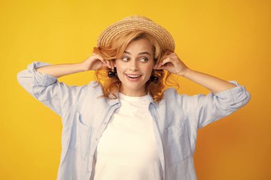 Cherry earrings. Portrait of beauty redhed woman with cherries on yellow isolated background