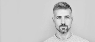 Man face portrait, banner with copy space. portrait of mature man. adult guy has graying hair. handsome man with grizzled beard