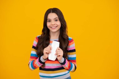 Şampuan kremi ve duş jeli olan genç bir kız. Genç kızın uzun saçı. Kozmetik ürünler, şampuan şişesi. Mutlu ergen, pozitif ve gülümseyen genç kız duyguları