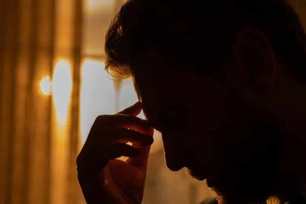 Stock image Stressed business man having headache at office. Tired businessman is working overtime and has headache. Overworked man with laptop at workplace, suffers from headache. Migraine from overwork