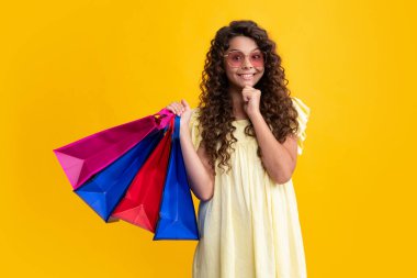 Teenager hold shopping bag enjoying sale. Child girl is ready to go shopping. Happy teenager, positive and smiling emotions of teen girl