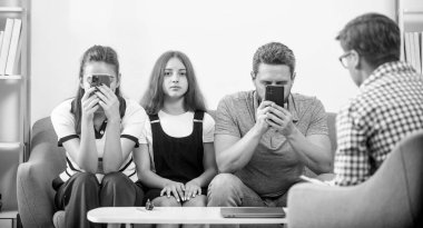 family therapy. parents with girl talk to social worker. phone addicted mom dad and daughter. life insurance and adoption. parent-teacher meeting. father mother and child at psychologist session.