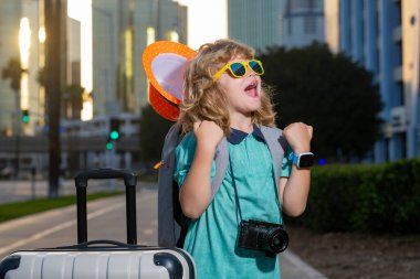 Child boy and travel Suitcase. Kid and Luggage Packed for vacation, child trip. Little tourist with travel bag. Child traveler and baggage. Kid with luggage bags going on holiday trip