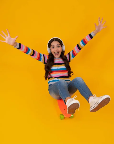 stock image Amazed teenager. Teen school girl with skateboard on studio isolated background. Spring schoolgirl trend, urban teenager style. Excited teen girl