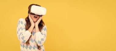 amazed teen girl wear vr glasses using future technology for education in virtual reality. Banner of child girl with virtual reality vr headset, studio portrait with copy space