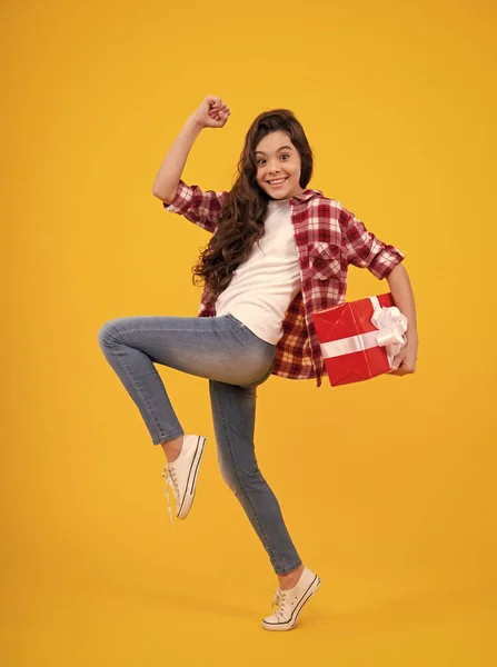 stock image Child with gift present box on isolated background. Presents for birthday, Valentines day, New Year or Christmas. Happy teenager, positive and smiling emotions of teen girl