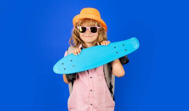 Child with skateboard in the studio. Kid having fun with penny board. Penny board, skateboard for children