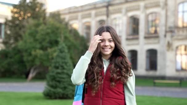 在户外为学校的少女感到高兴 外面的女学生 带着背包上学的少女 在公园里学龄少女的慢动作 — 图库视频影像
