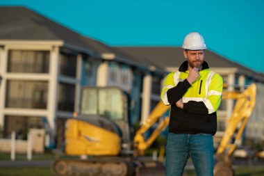 Worker at building site. Construction manager in helmet. Male construction engineer. Architect at a construction site. Handyman builder in hardhat. Building concept. Builder foreman