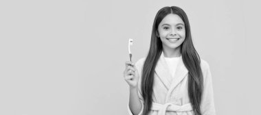dental health and beauty. oral care. self hygiene. daily habit. happy teen girl hold toothbrush. Banner of child girl with teeth brush, studio portrait, header with copy space