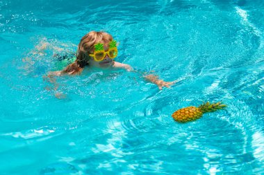 Summer beach. Kid in swimming pool, tropical sea water