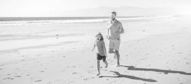 Father and son run on summer beach outdoor, banner poster with copy space, father and son family running on summer beach, family fun.