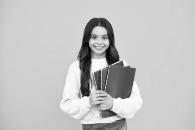 Teenage school girl with books. Schoolgirl student. Happy face, positive and smiling emotions of teenager girl
