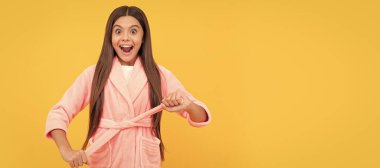 amazed teen girl in home terry bathrobe, homewear. Child face, horizontal poster, teenager girl isolated portrait, banner with copy space