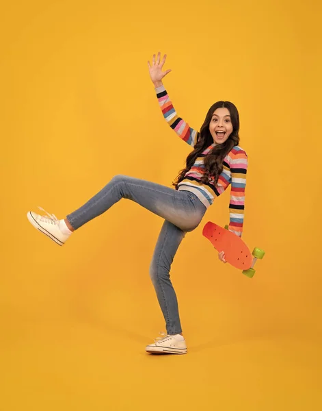 stock image Amazed teenager. Beautiful and fashion young teen girl posing with skateboard. Teenager street fashion lifestyle. Excited teen girl