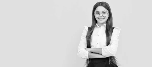 stock image happy kid in school uniform and glasses for vision protection. Child face, horizontal poster, teenager girl isolated portrait, banner with copy space