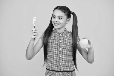 Girl cleaning teeth. Kid brushing teeth with brush. Dental hygiene, tooth care. Girl cares about health of his teeth. Happy teenager, positive and smiling emotions of teen girl